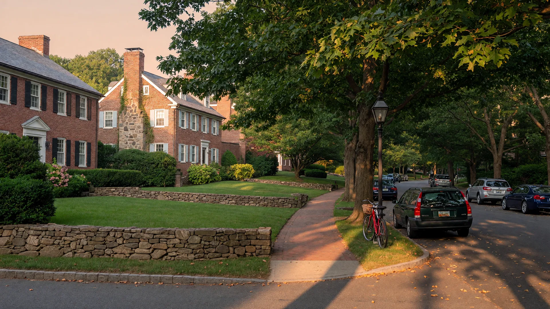 Tree-lined residential street in Bethesda Maryland in late summer with classic brick and fieldstone colonial homes and golden light filtering through mature trees