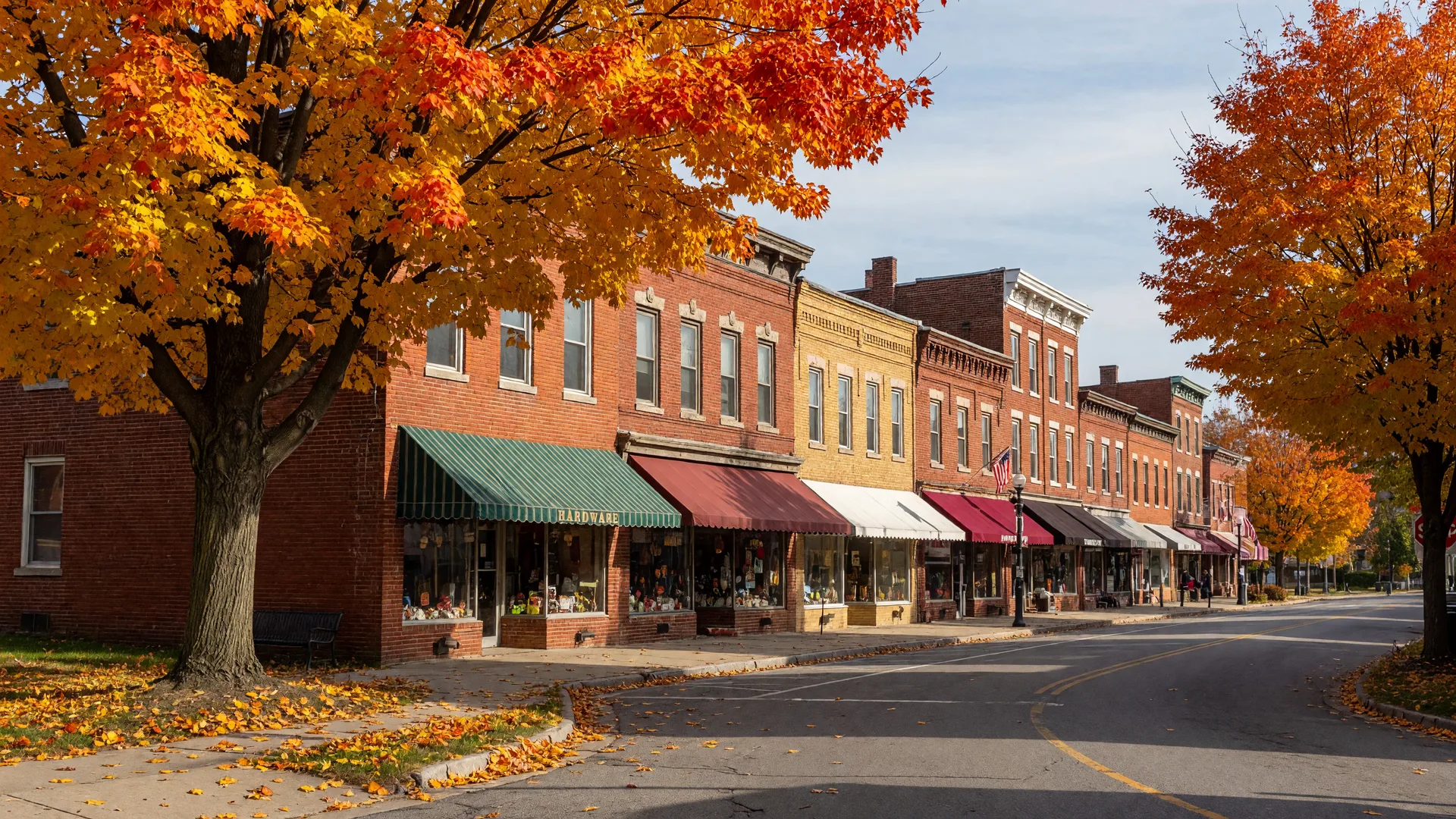 Red-brick storefronts and golden maples on an October morning in Indiana, PA