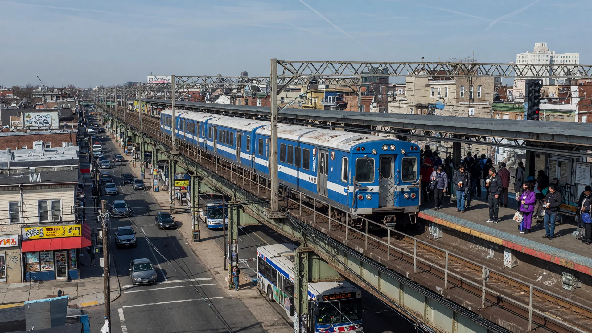 SEPTA Ardmore station with regional rail train and commuters on platform