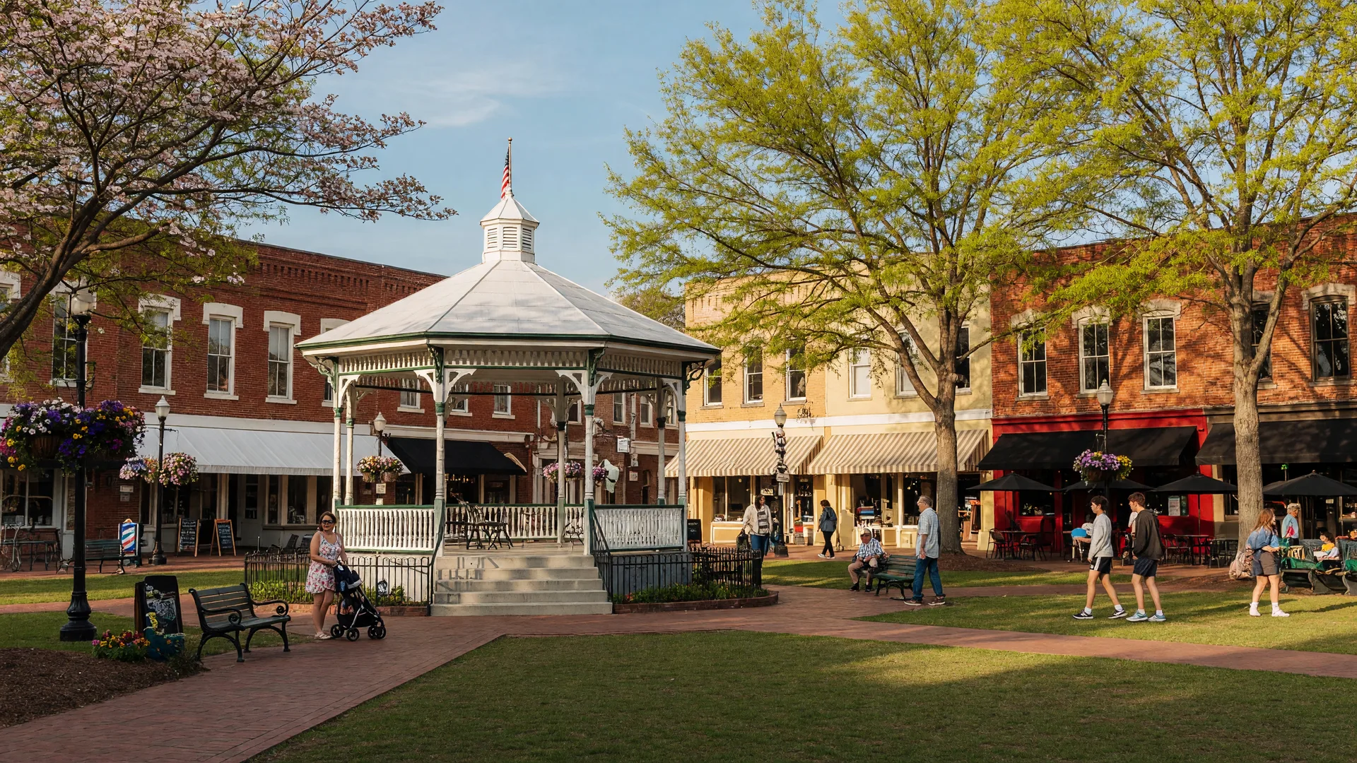 Marietta Square featuring Glover Park bandstand, historic brick storefronts, and shops on a sunny afternoon
