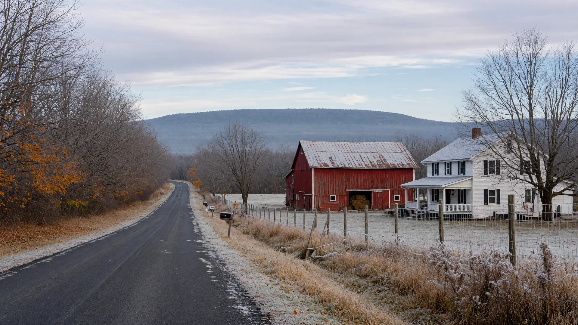 Frost on a Lehigh Valley country lane in mid-November, with mostly bare trees, a weathered red barn, a white farmhouse, and the Blue Mountain ridge on the horizon under a soft overcast sky