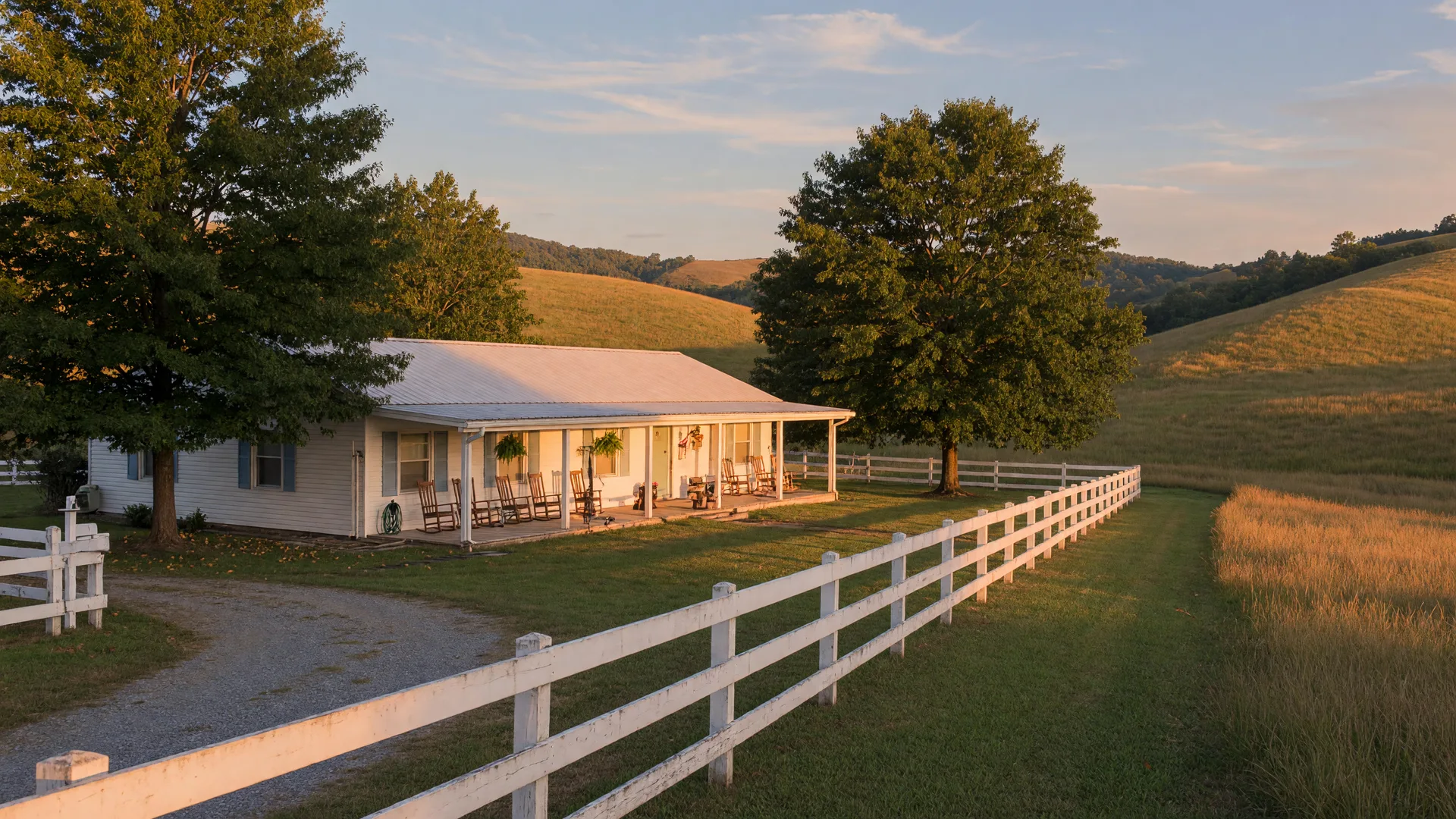 A peaceful single-story Kentucky home with a covered porch and rocking chairs set among rolling bluegrass hills at golden hour
