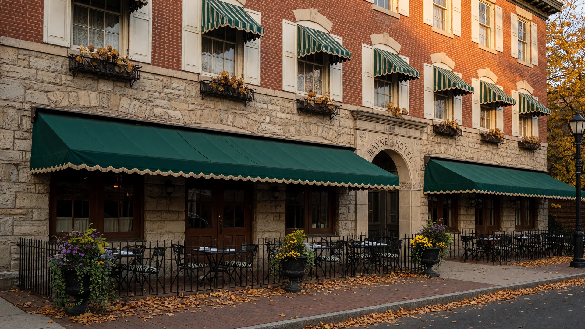 Historic Wayne Hotel facade with outdoor dining area and Lancaster Avenue storefront