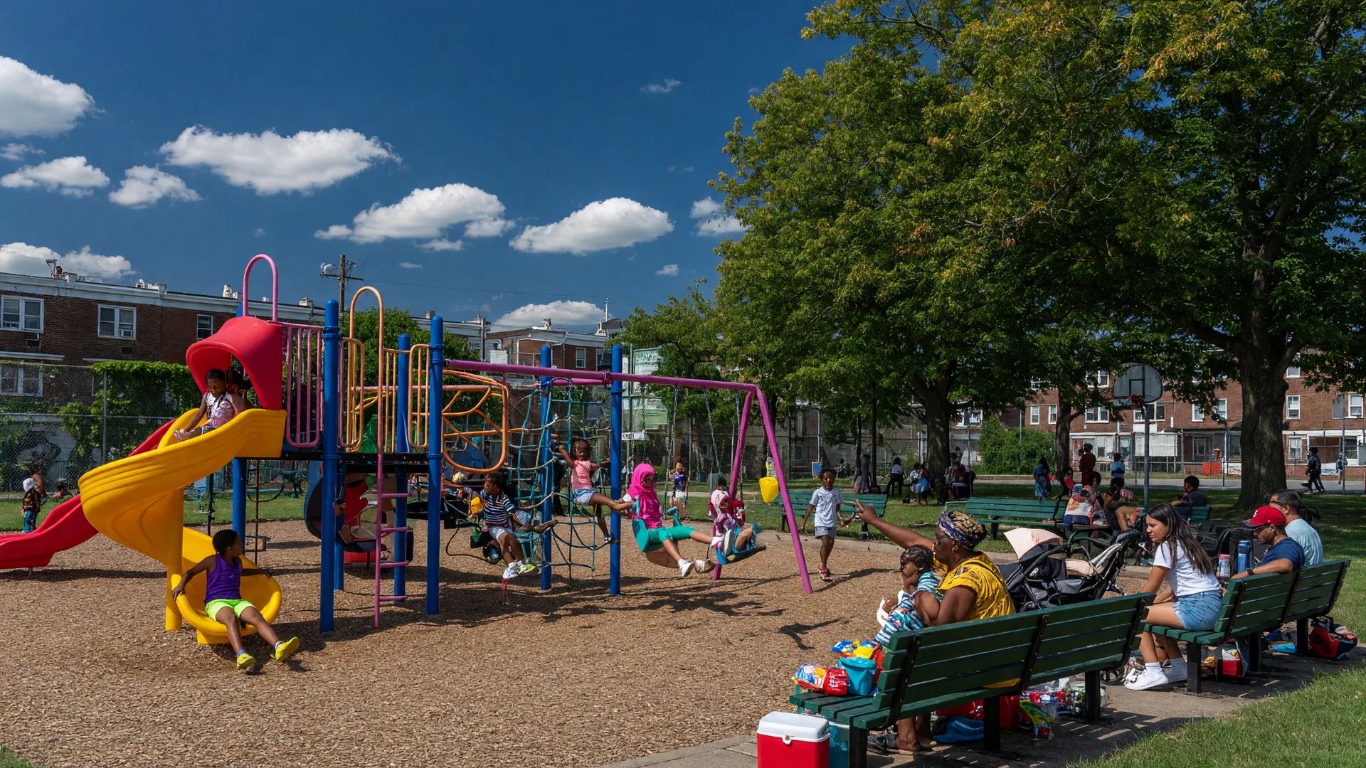 Chew Playground in Point Breeze, Philadelphia with children playing on colorful playground equipment
