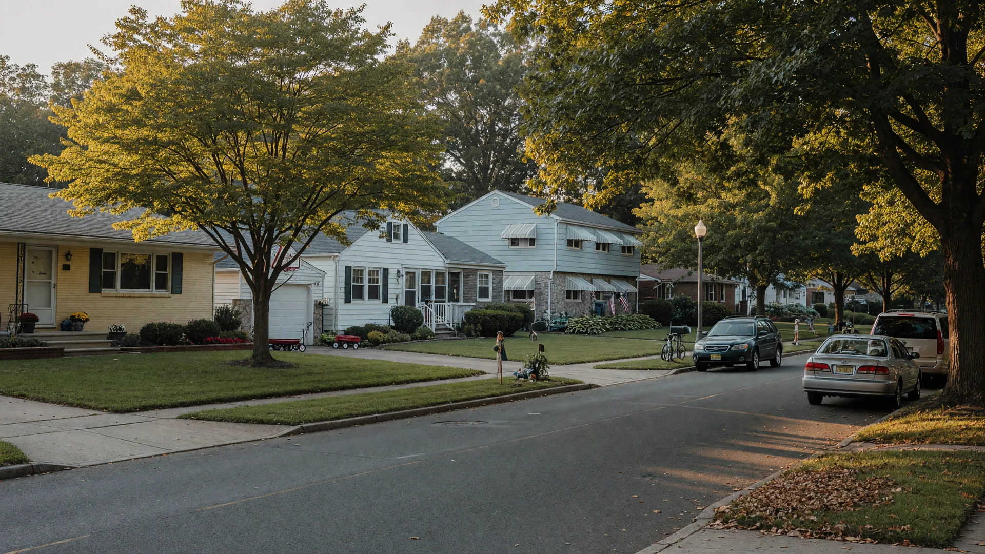 Quiet suburban street in Clifton, New Jersey with mid-century single-family homes and mature shade trees