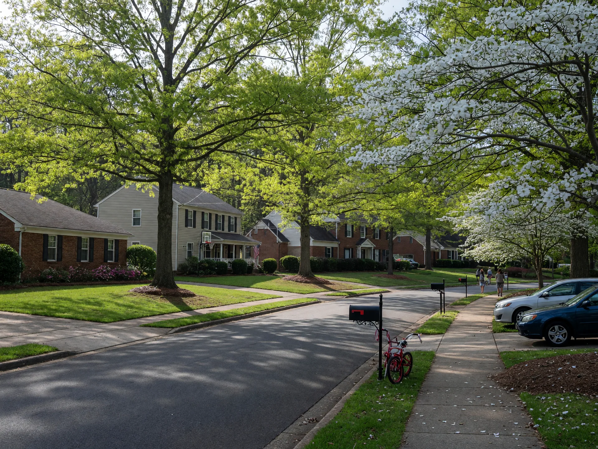Leafy residential street in Metro Atlanta with brick ranch and two-story family homes