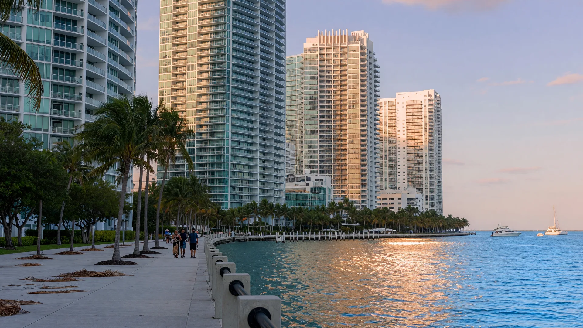 Glass condominium towers along the Brickell Baywalk above Biscayne Bay