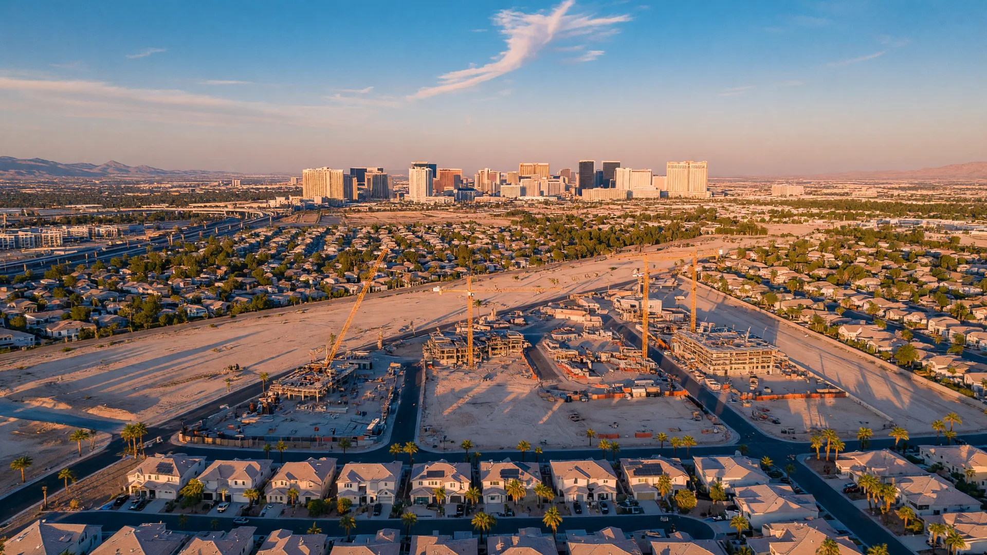 Aerial view of the Las Vegas valley at golden hour showing new construction and residential neighborhoods