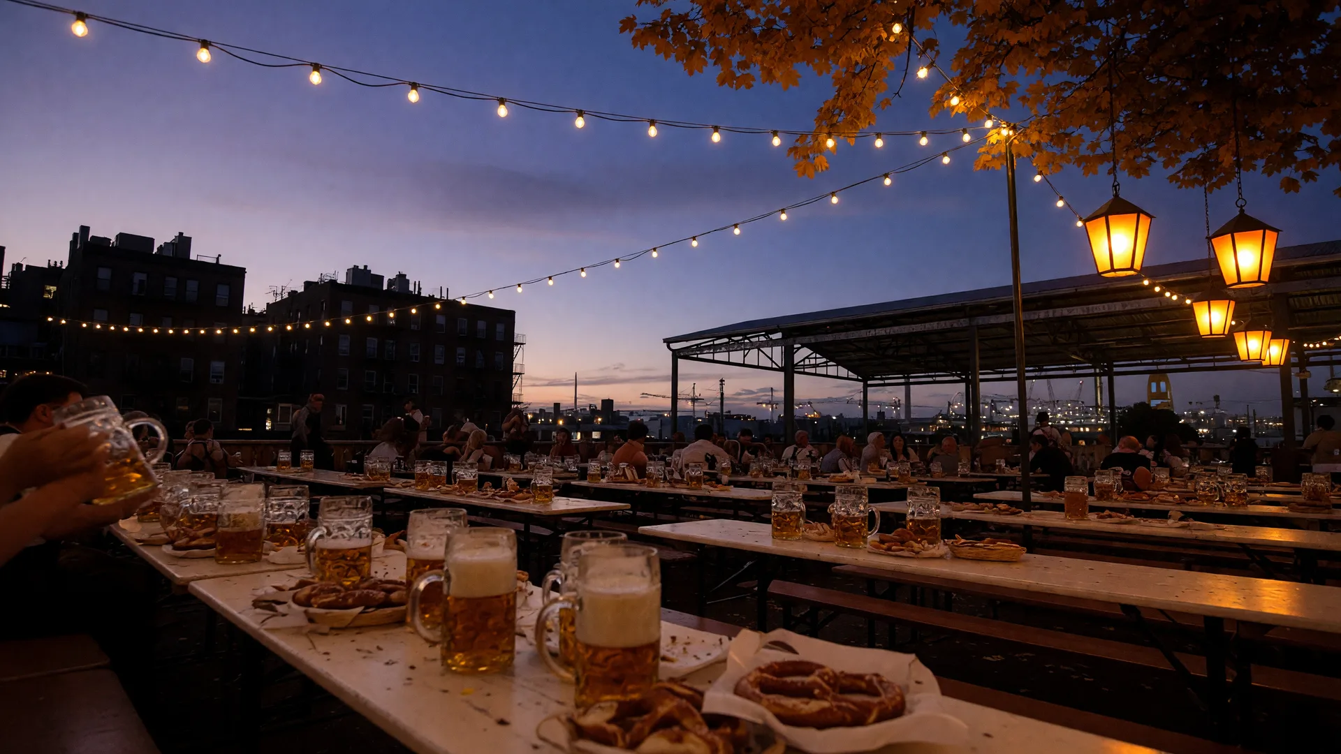 Wooden tables with frothy beer steins and soft pretzels at an Oktoberfest beer garden at dusk under warm string lights, with brick rowhouse and pavilion silhouettes evoking Washington, DC neighborhoods