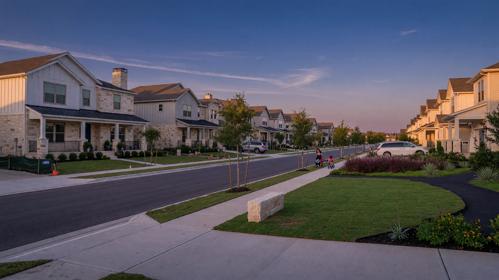 New construction homes in a North Texas master-planned community at golden hour with wide lots and a landscaped common green