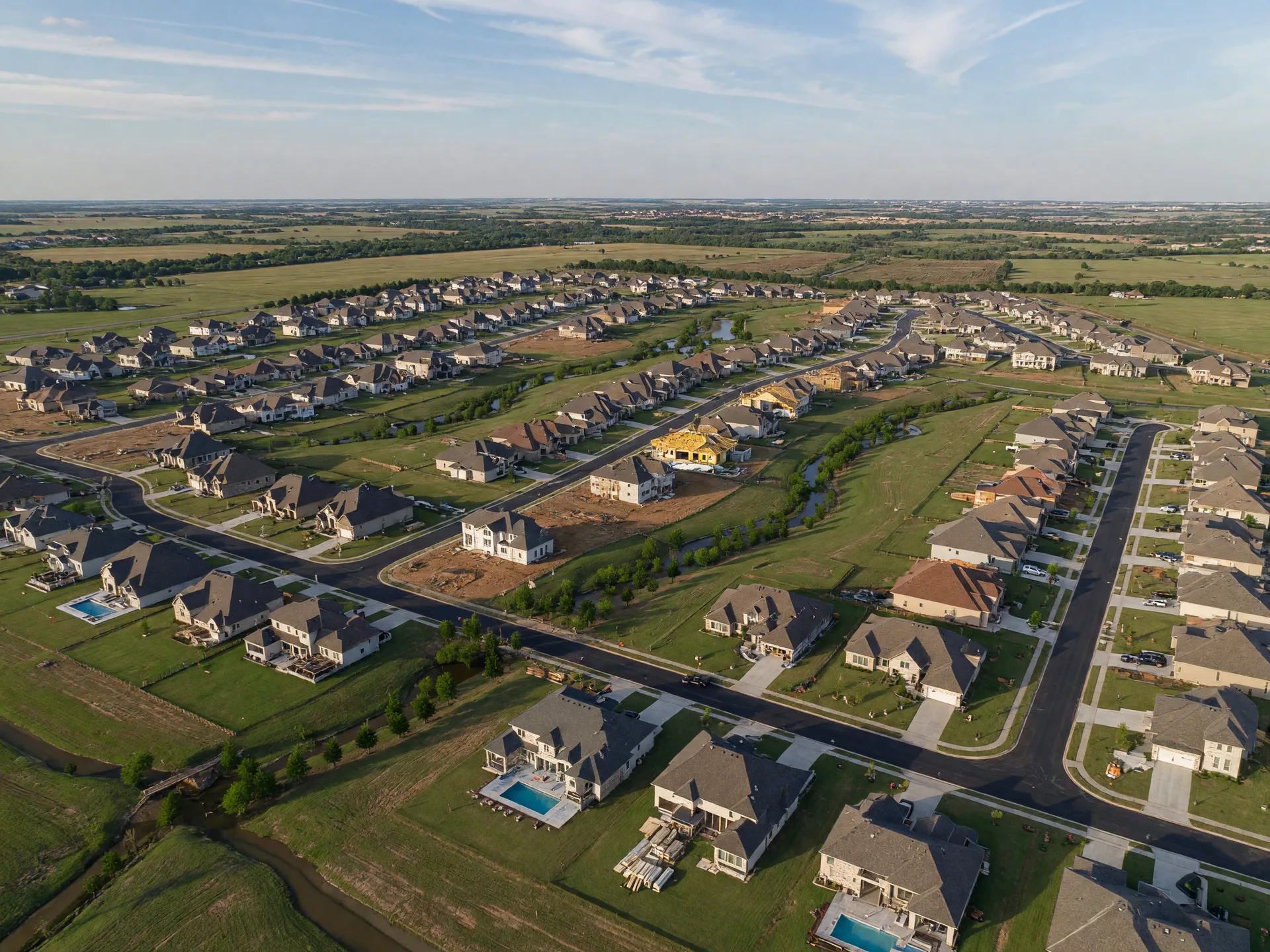 Aerial view of wide estate homesites with greenbelts and sidewalks in west Flower Mound, Texas