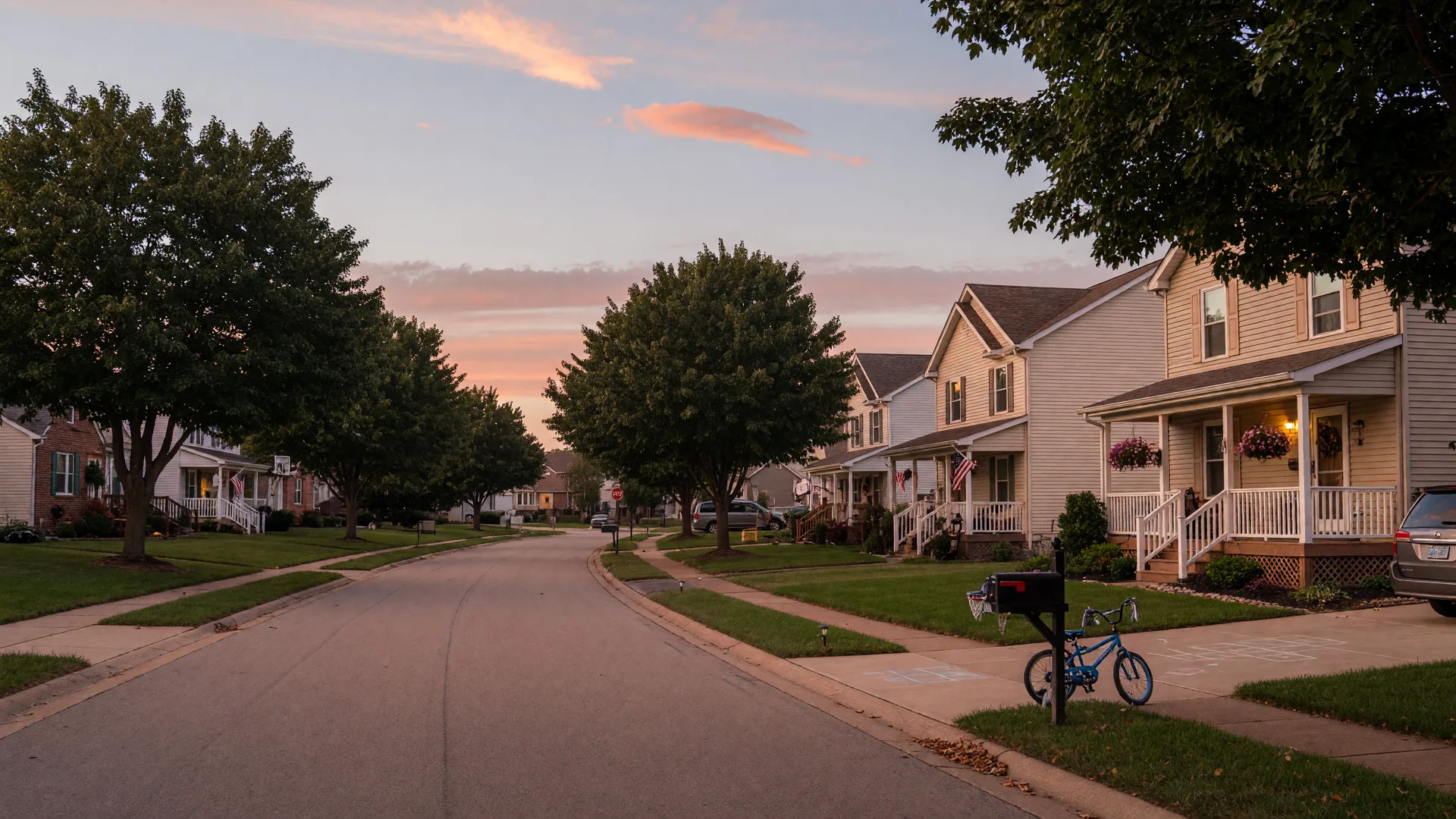 A quiet tree-lined street in suburban Stark County Ohio at dusk