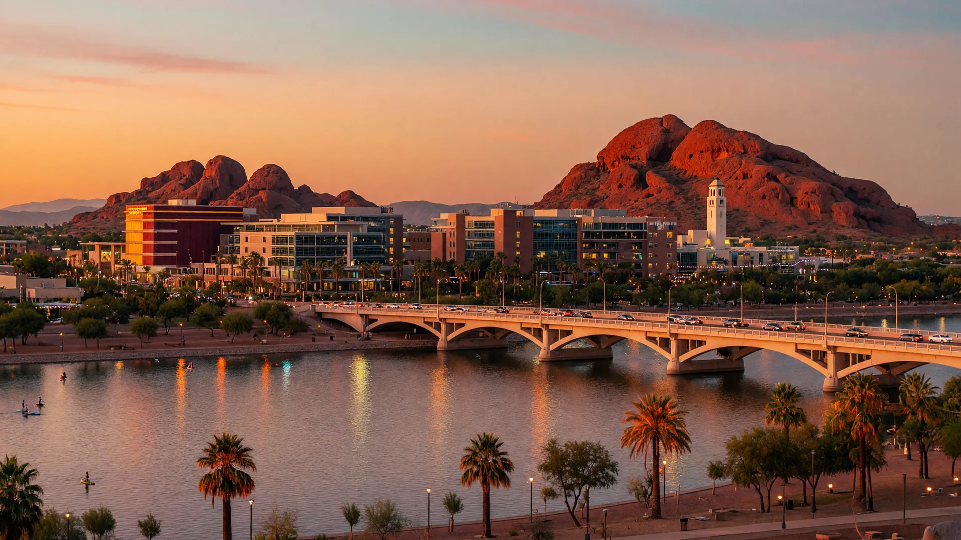 Golden hour view of Tempe Town Lake with the Mill Avenue bridge and ASU skyline beyond the water