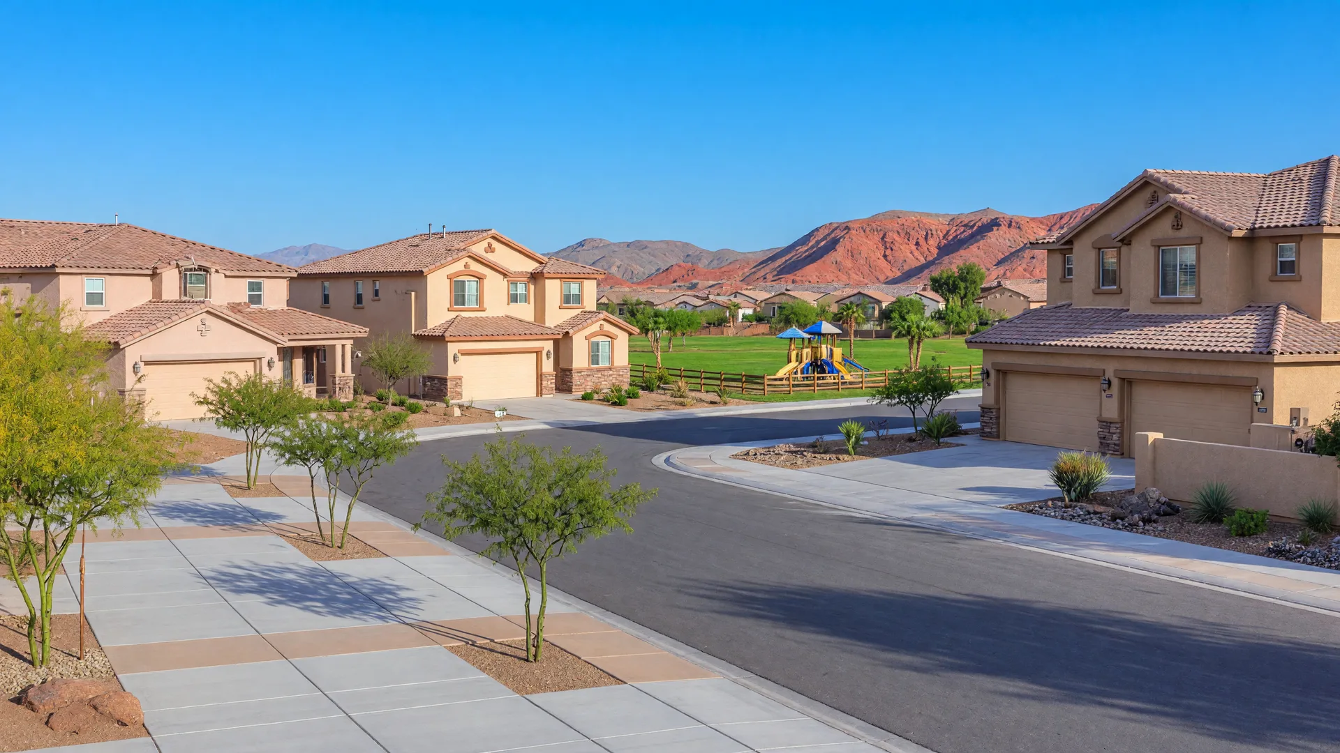 Tree-lined street in an established Las Vegas desert neighborhood with a mix of single-story and two-story stucco homes and mountains in the distance
