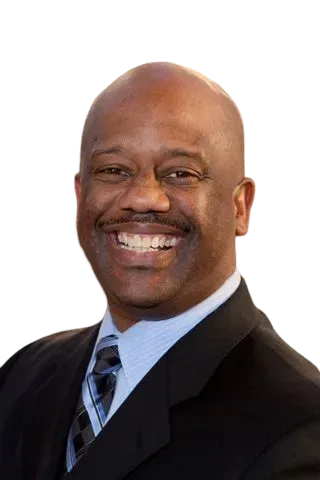Cut-out portrait of Steve Lockhart, a smiling man with a shaved head in a black suit and light blue shirt