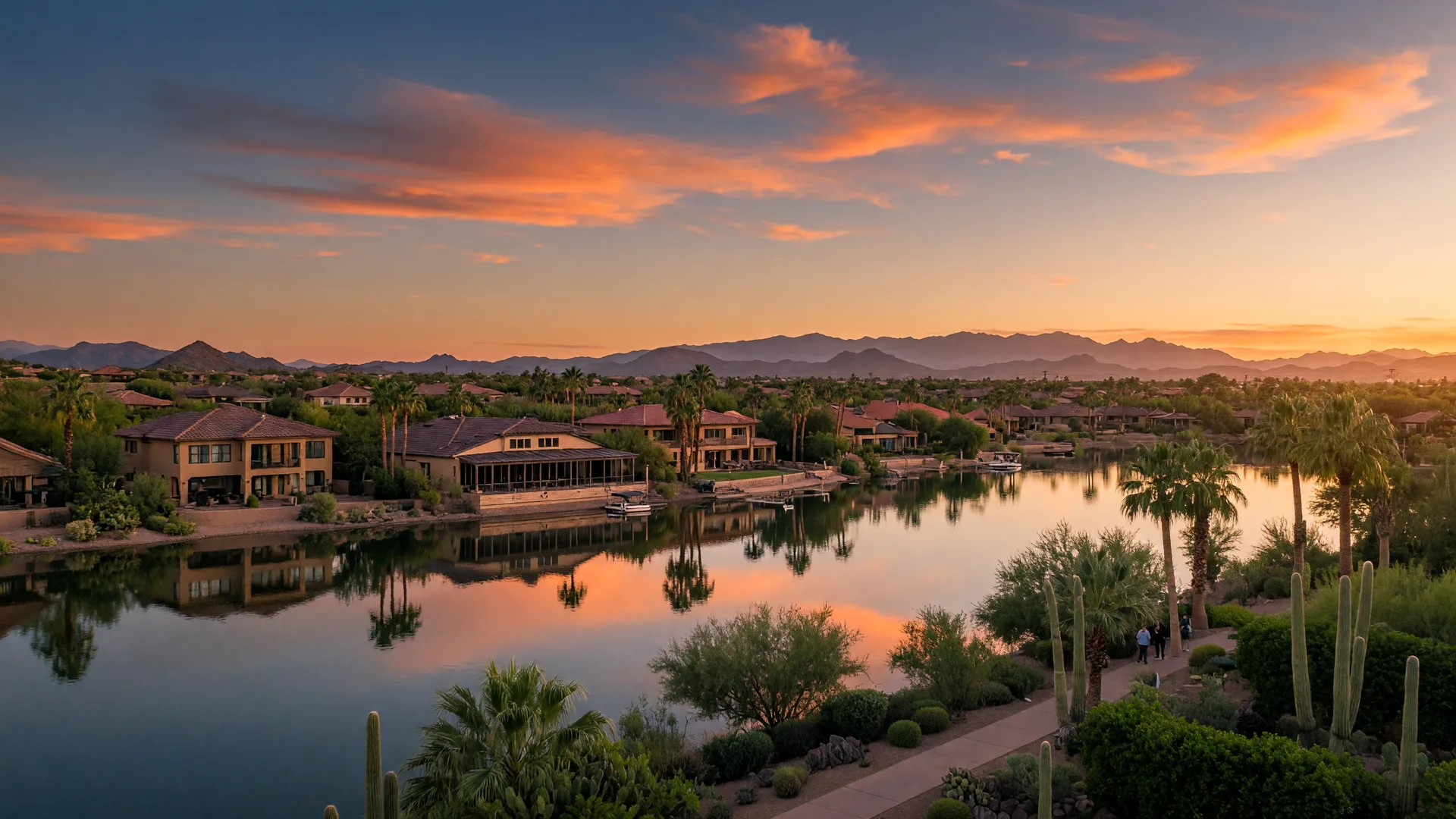 Established Arizona lake community with luxury homes lining a calm waterfront at golden hour