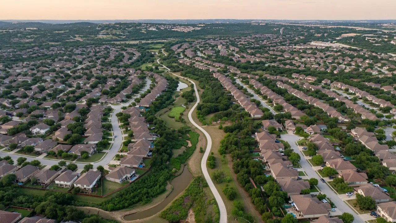 Aerial view of dense suburban master-planned neighborhoods in far north San Antonio with greenbelts and a trail system