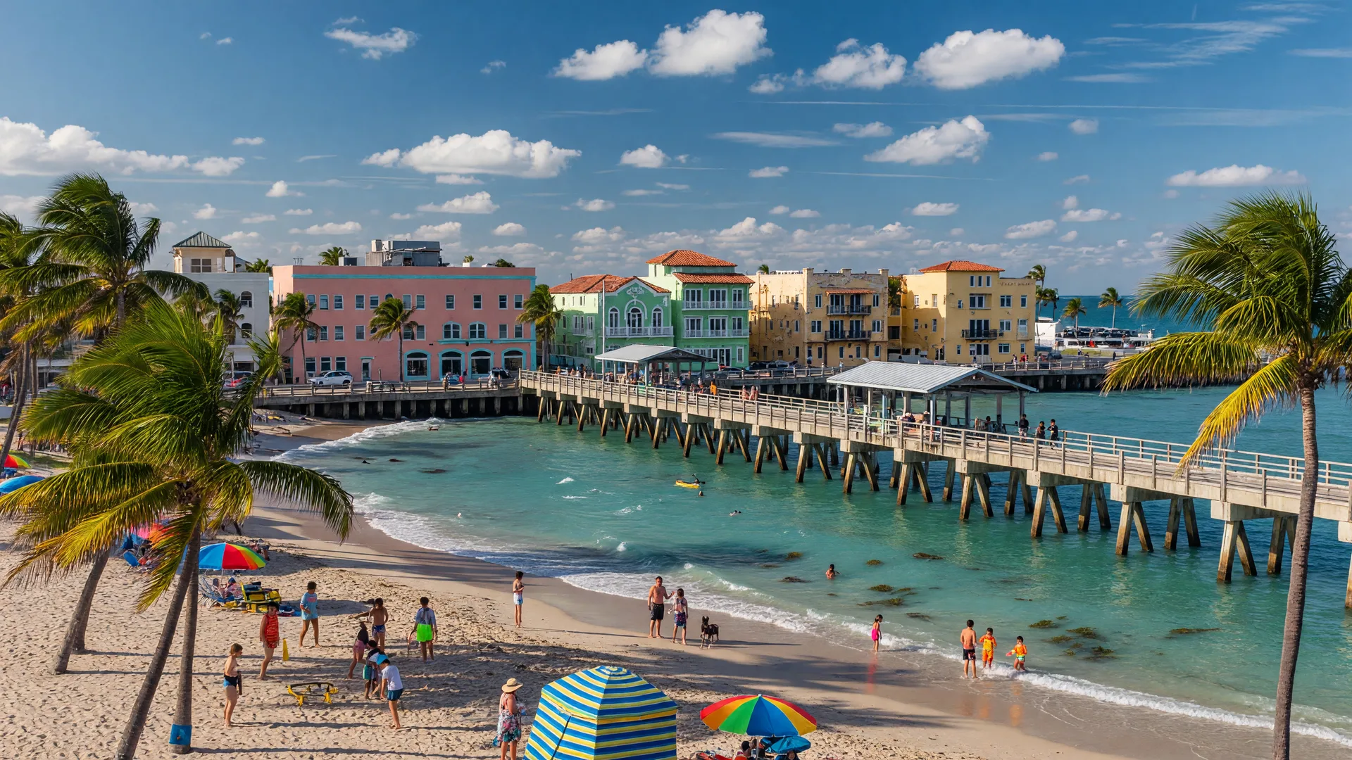 Lake Worth Beach Florida pier and coastline on a bright summer afternoon with beachgoers and historic architecture.