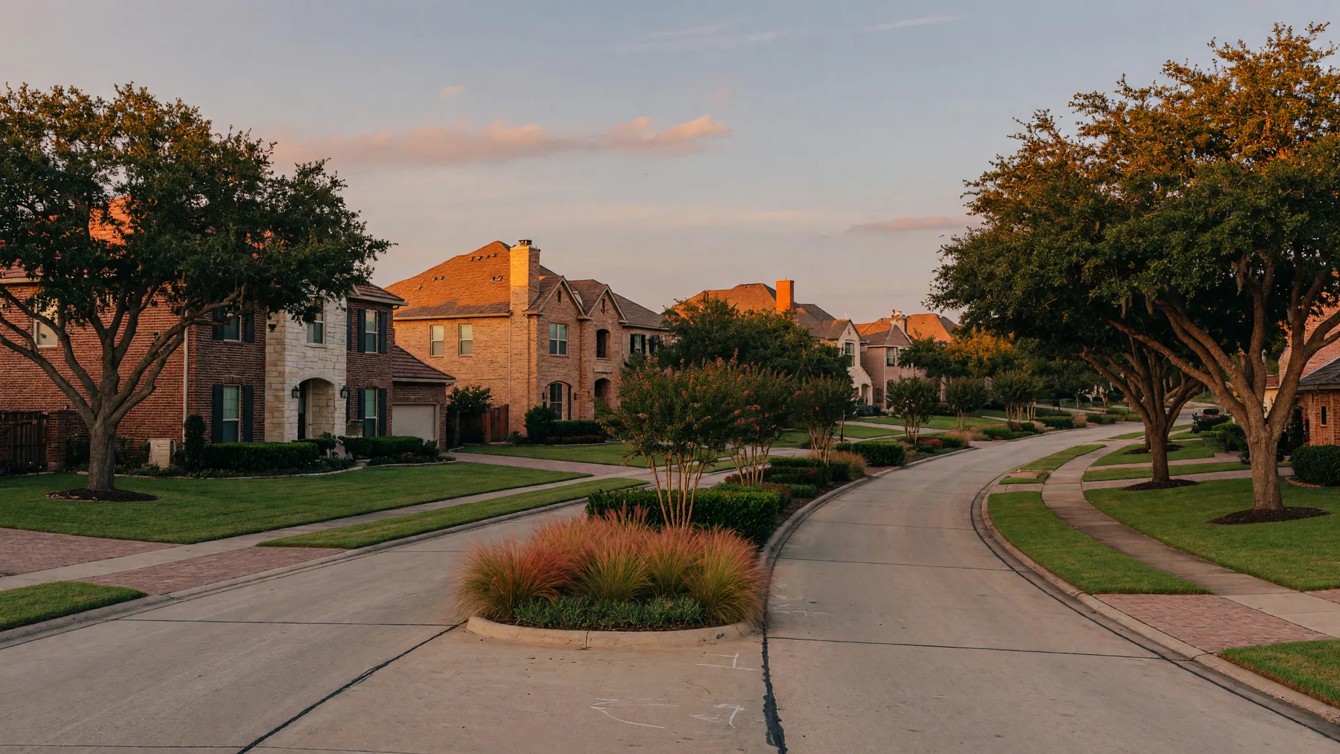 Golden-hour view down a quiet street of brick and stone homes in a master-planned Fulshear community