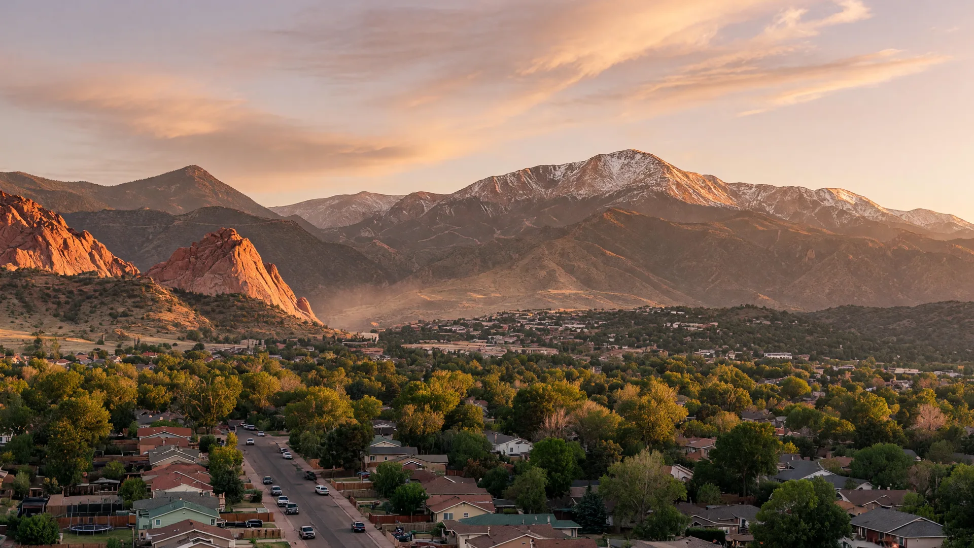 Colorado Springs with Pikes Peak rising behind the city at golden hour