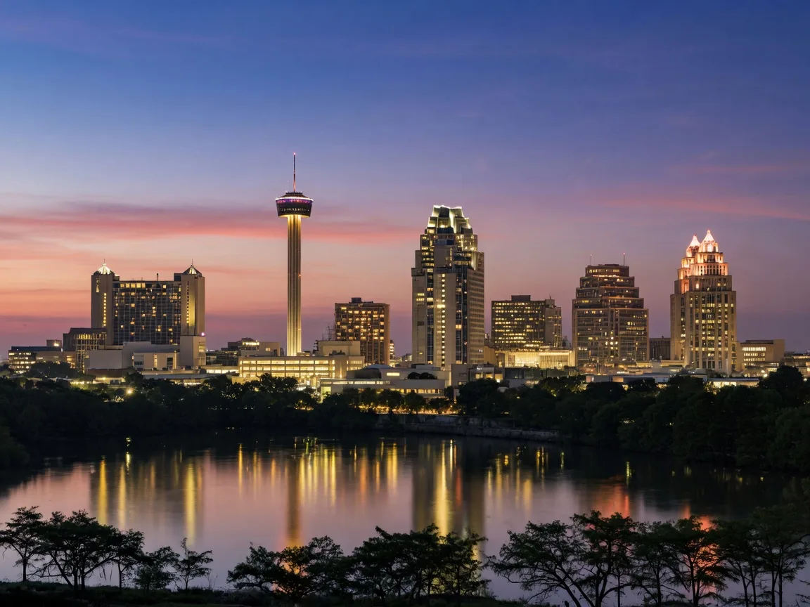 The San Antonio skyline at dusk with the Tower of the Americas glowing above the river