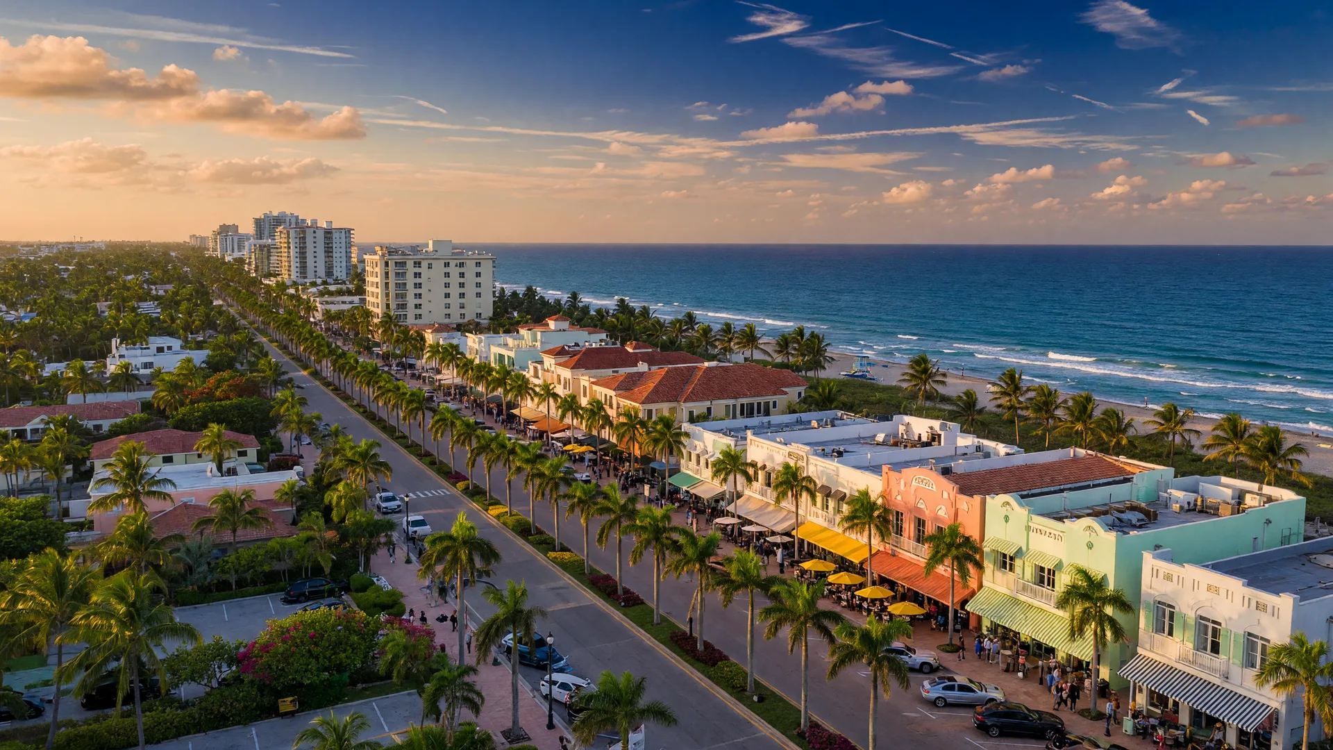 Aerial view of Delray Beach showing Atlantic Avenue, palm trees, and the beach at golden hour