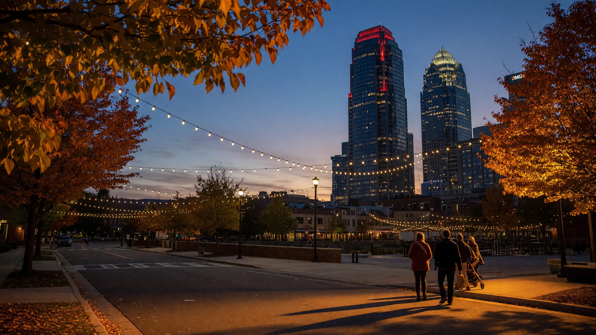 Crisp fall evening in Uptown Charlotte with amber autumn leaves in the foreground and the city skyline behind