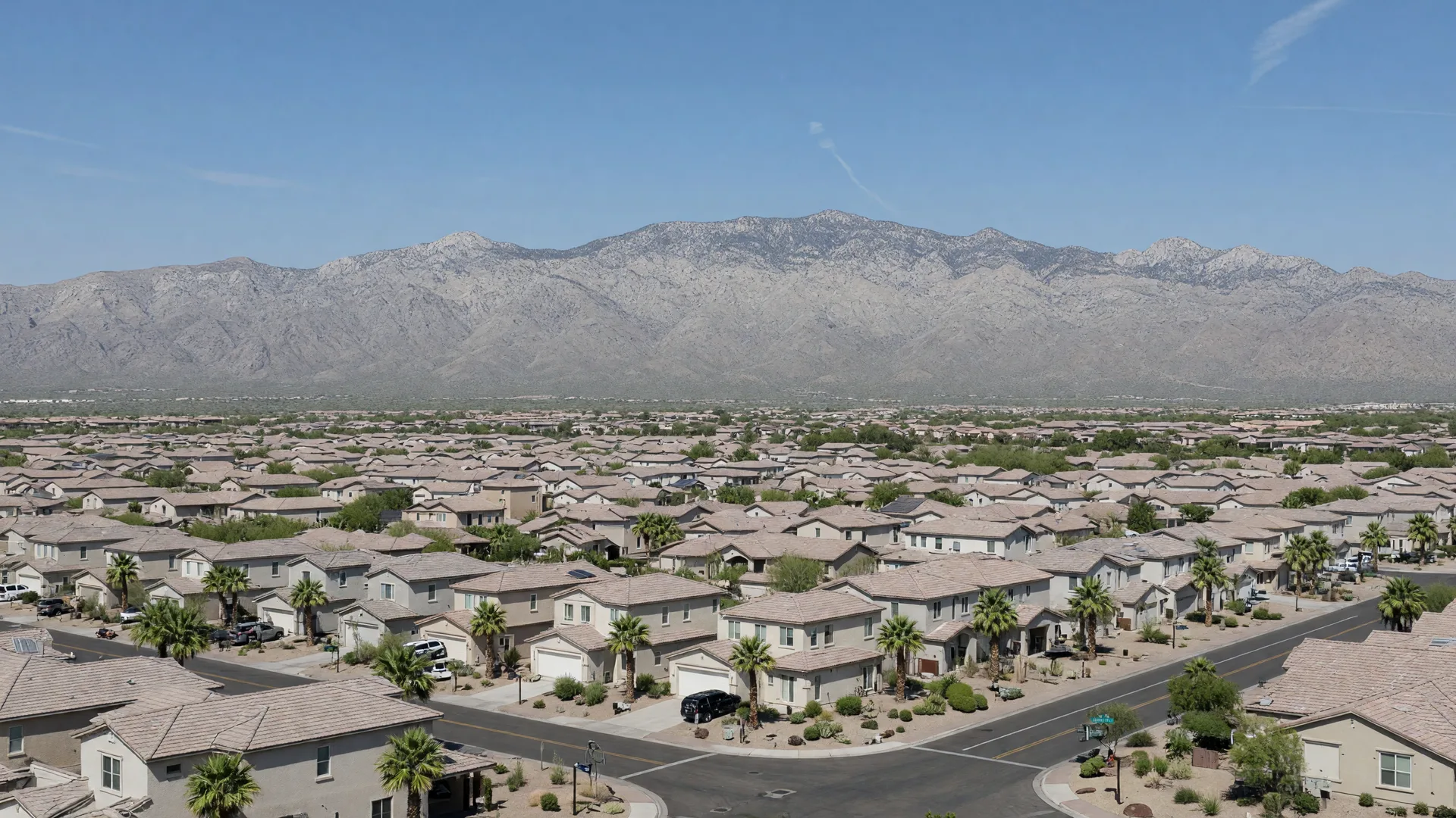 Golden hour aerial view of Buckeye, Arizona, with master-planned communities spread across the desert and the White Tank Mountains on the horizon