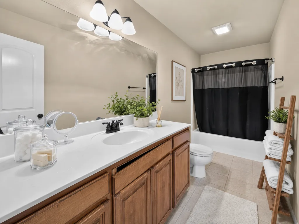 Guest bath, virtually staged with towels and a plant