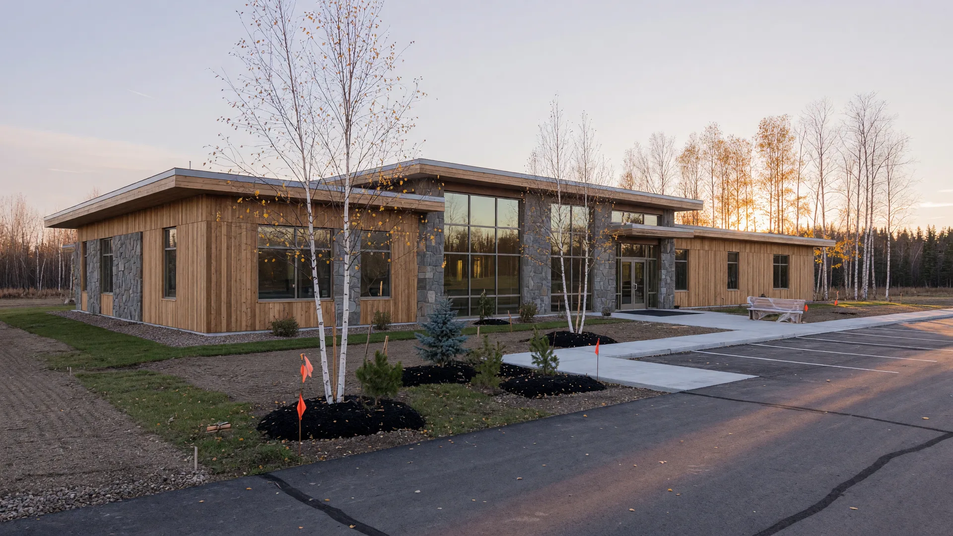 New wood and stone medical clinic building with tall windows and fresh landscaping in northern Minnesota