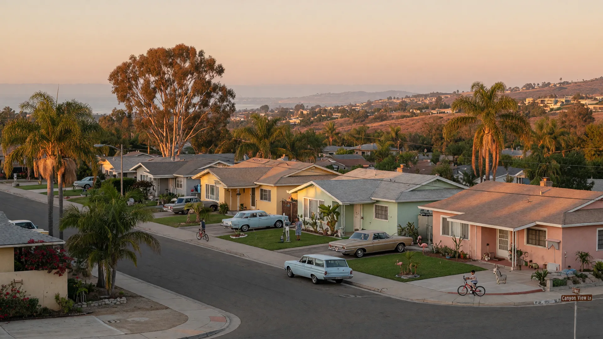 Single-story mid-century ranch homes on a palm-lined San Diego street at golden hour, with rolling hills and a coastal haze on the horizon