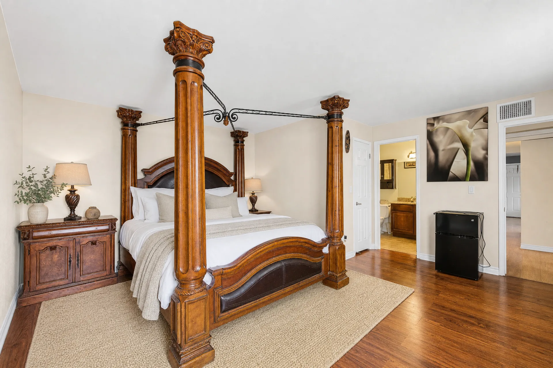 Virtually staged master bedroom with a four-poster bed and neutral walls