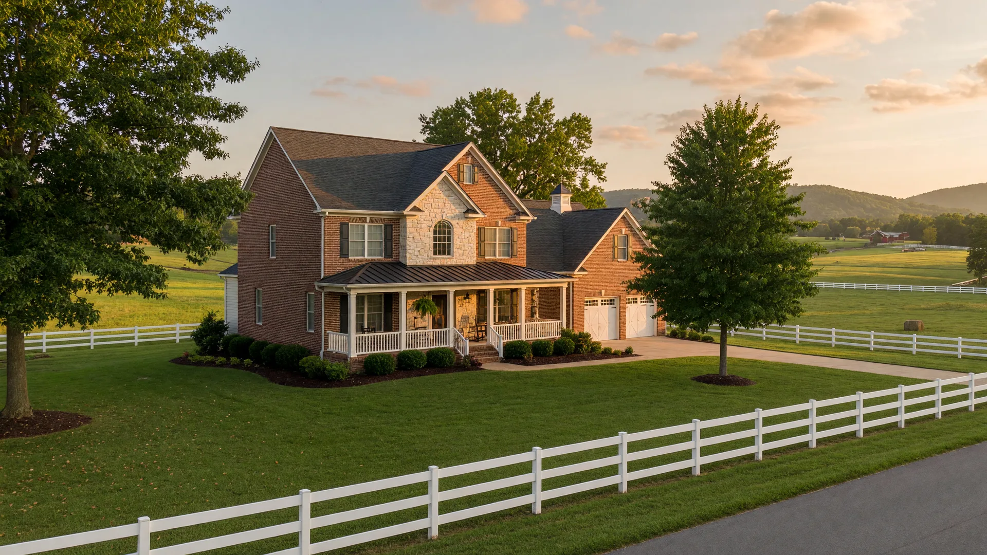 Brick-and-stone family home on rolling Middle Tennessee pasture at golden hour