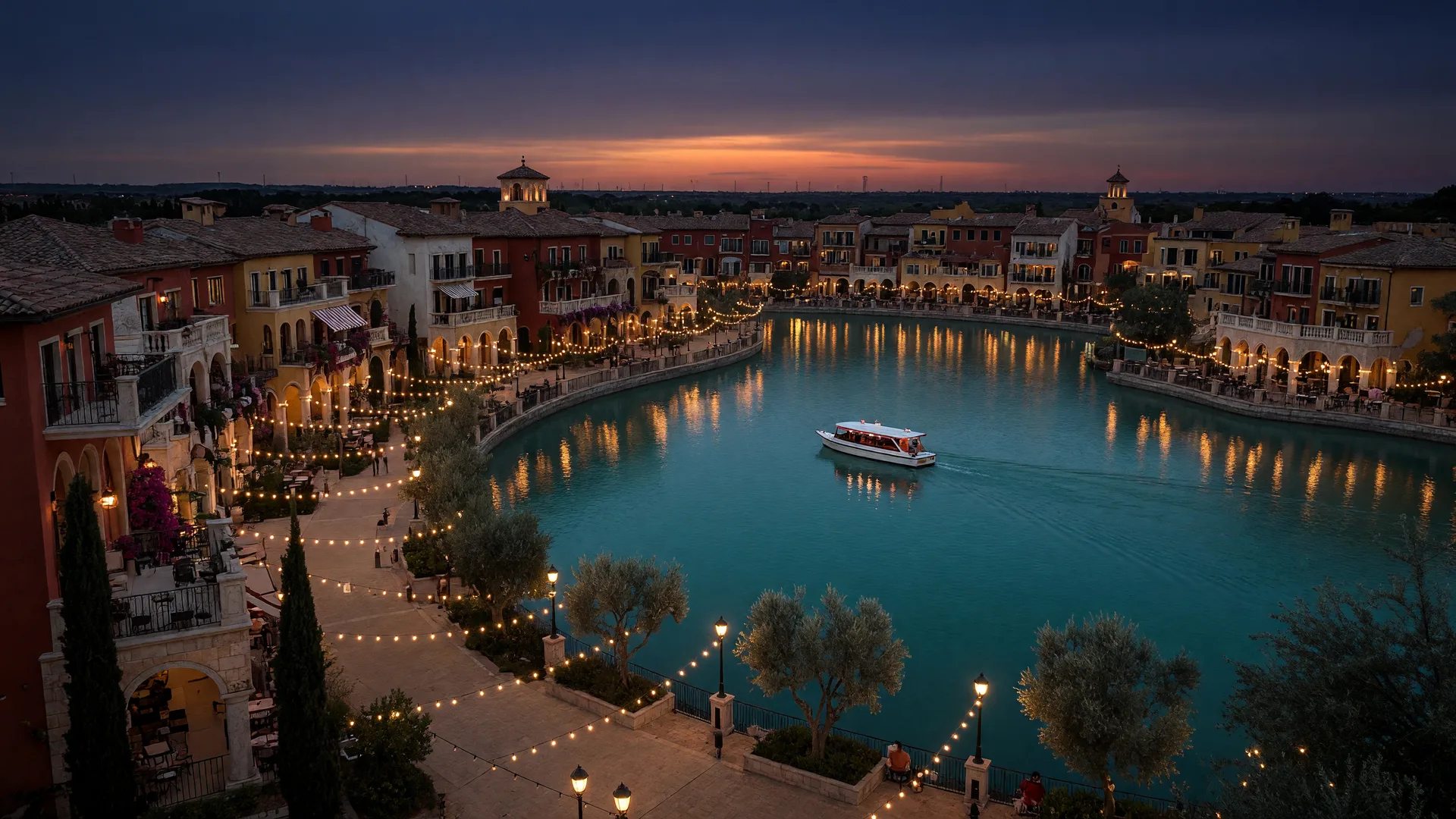 Conceptual view of The Marco in Prosper, an Italian-inspired village with warm-lit facades and a water taxi lining a lagoon at dusk