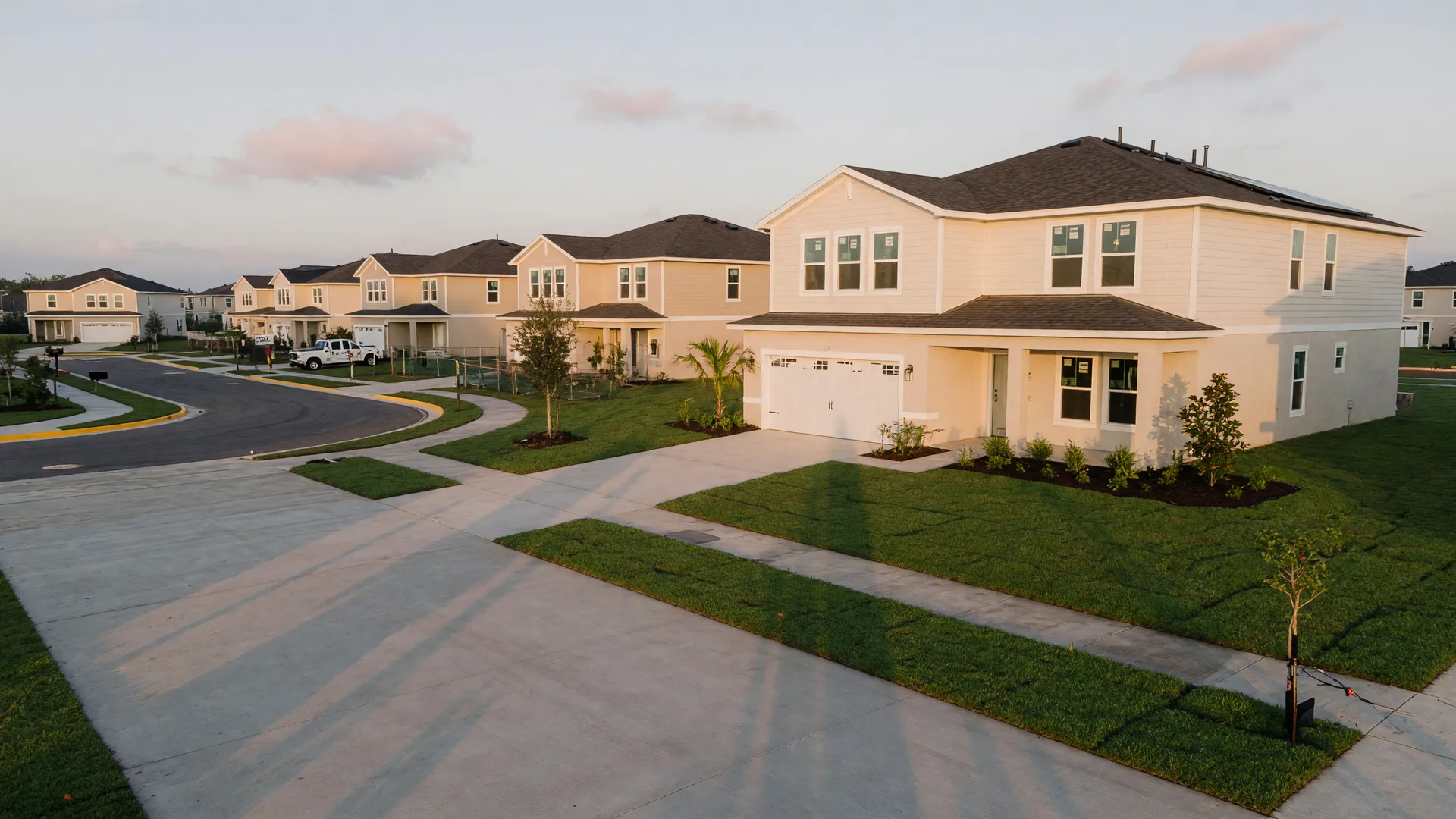 A new DR Horton home in a quiet Polk County community at dawn with a wide paved driveway