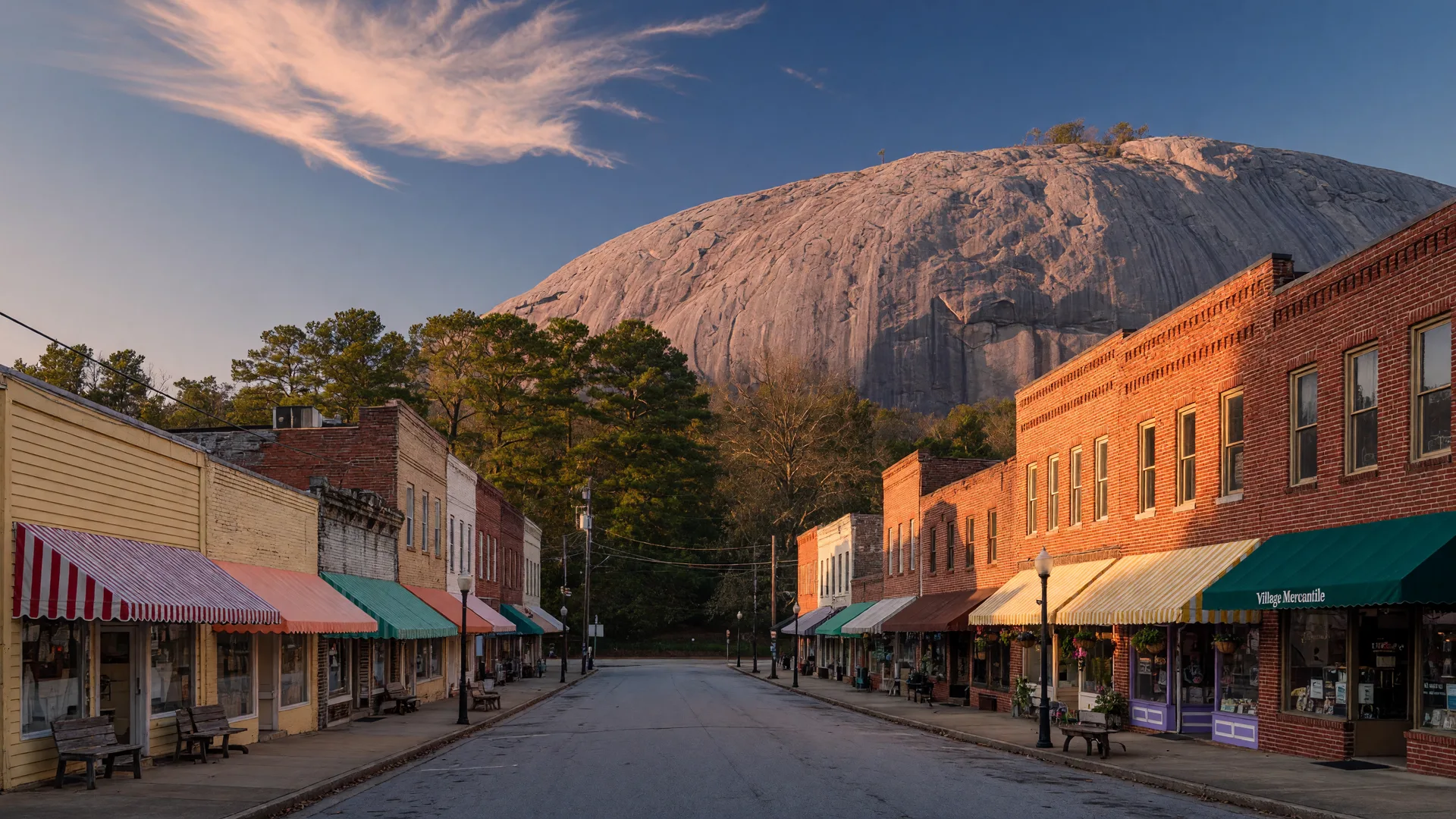 Historic Stone Mountain Village Georgia main street with early 1900s storefronts and the granite dome of Stone Mountain rising behind the trees