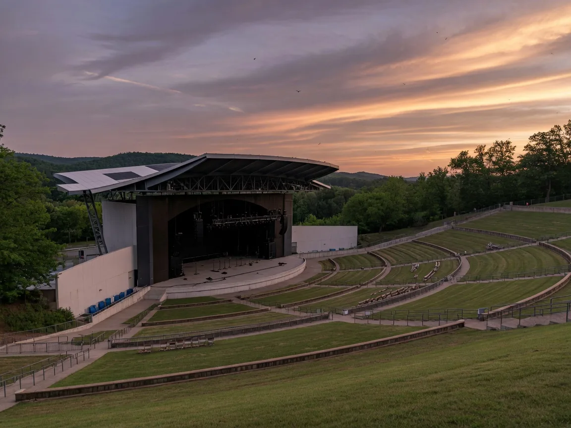 Jiffy Lube Live outdoor amphitheater in Bristow, Virginia with its stage, lawn seating, and dramatic summer evening sky