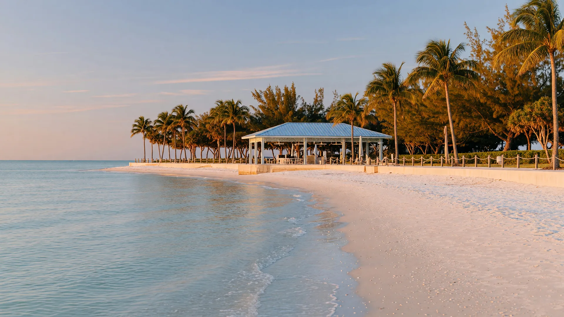 Calm white sand beach with palms and a covered pavilion at Lido Beach, Sarasota