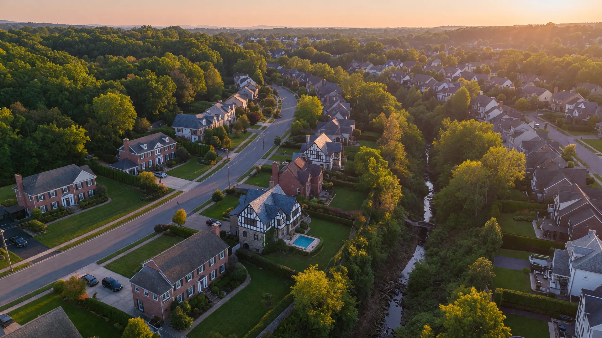 Aerial view of upscale wooded neighborhoods in Huntingdon Valley at golden hour