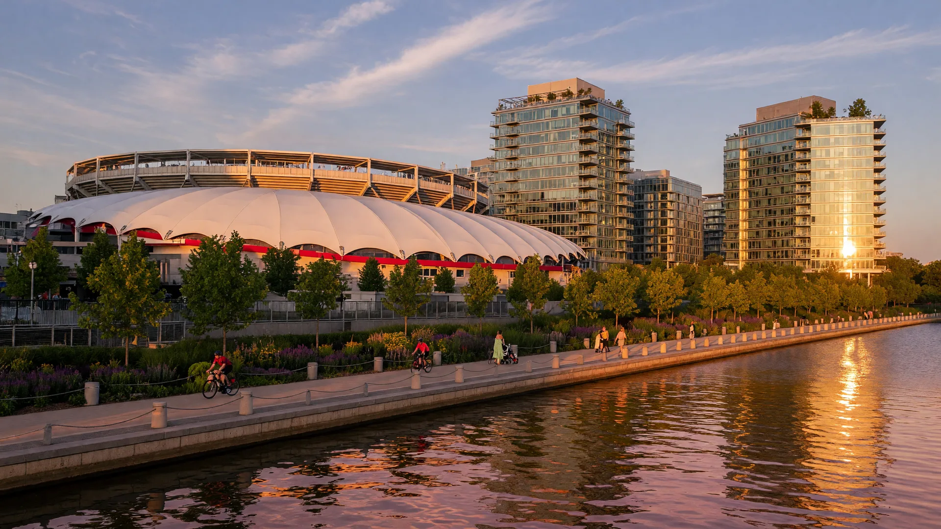 The Navy Yard waterfront in Washington, DC at golden hour with Nationals Park, glass condominium towers, and the Anacostia River in the foreground