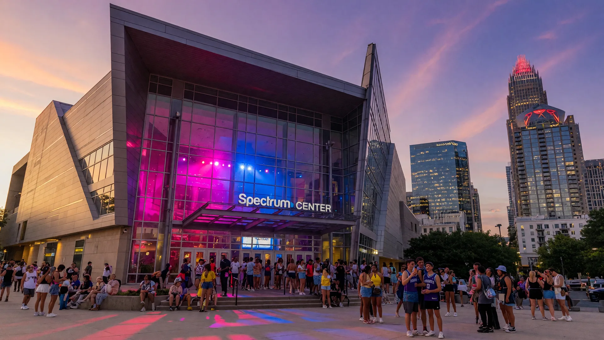 Bank of America Stadium in Charlotte NC illuminated at dusk with MLS All-Star branding, fans arriving for a match against the Uptown skyline