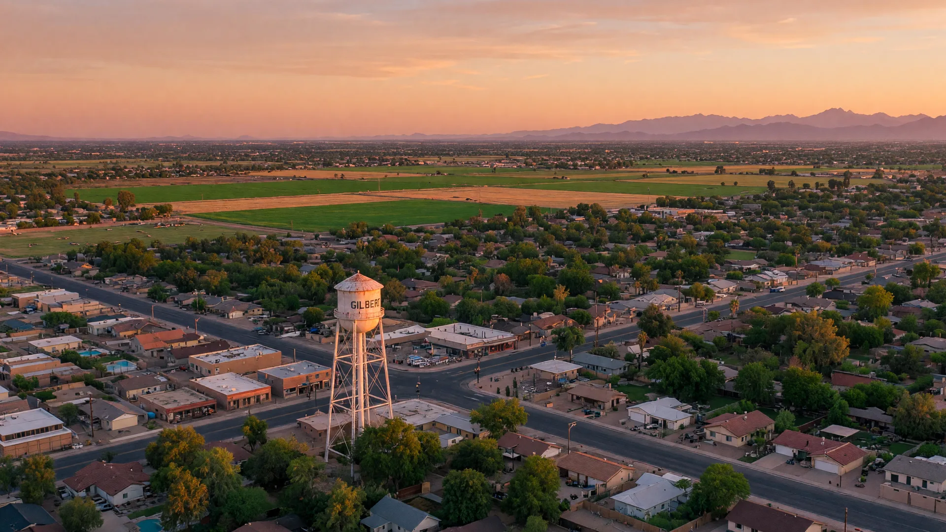Golden hour view of Gilbert, Arizona, with the historic water tower above tree-lined family neighborhoods