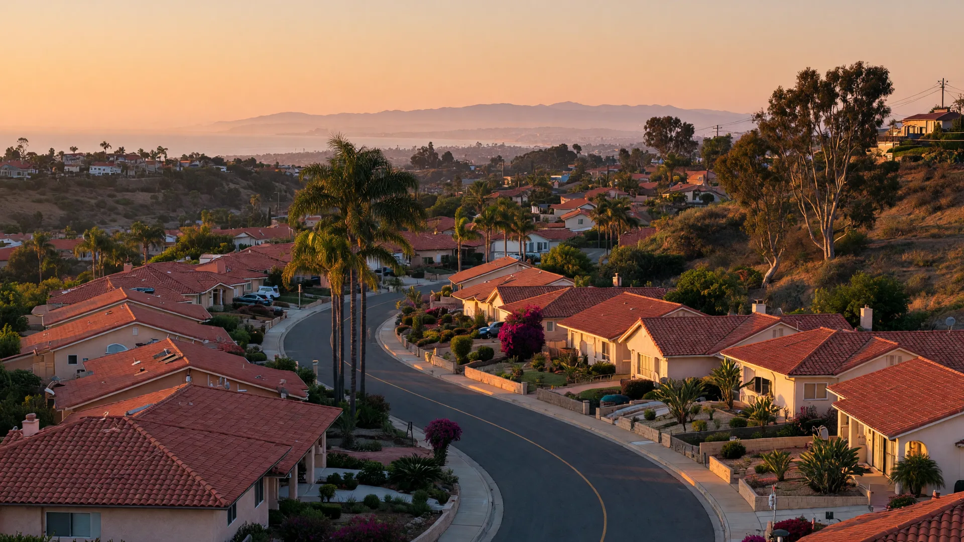A San Diego County hillside neighborhood of tile-roofed homes in warm golden-hour light