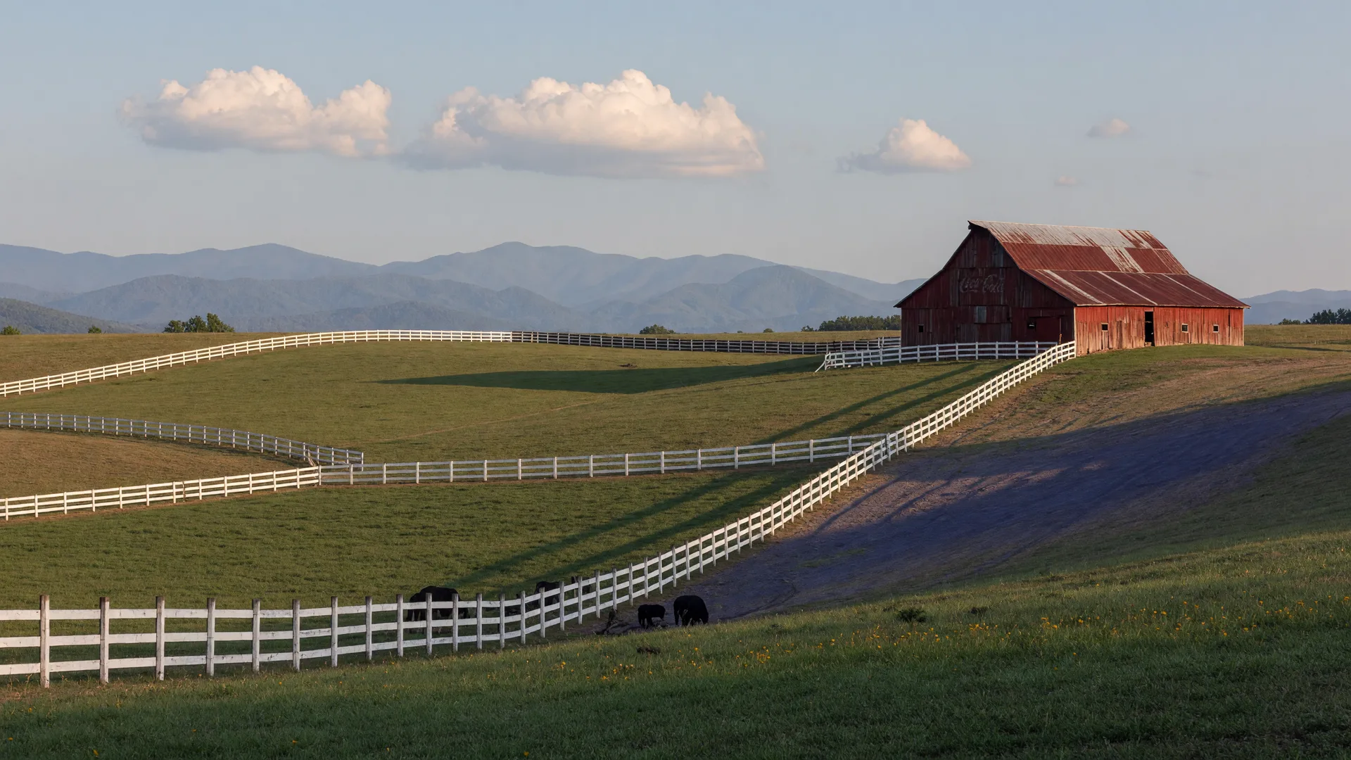 Rolling farmland with a red barn in the northeast Georgia foothills of Banks County