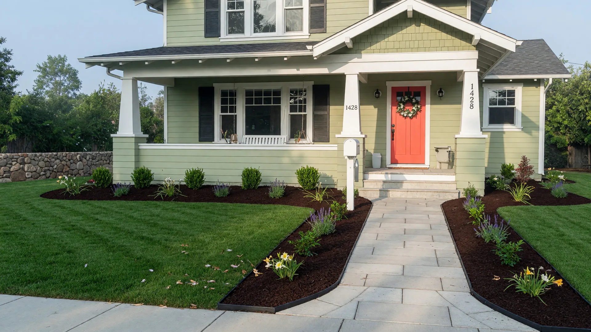 A freshly painted craftsman-style home with new mulch beds and a bright front door ready for sale