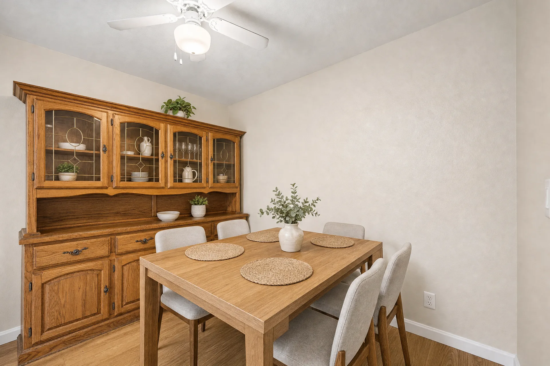 Virtually staged dining area with a wooden hutch and table seating at 2451 Rainbow Blvd Unit 2122