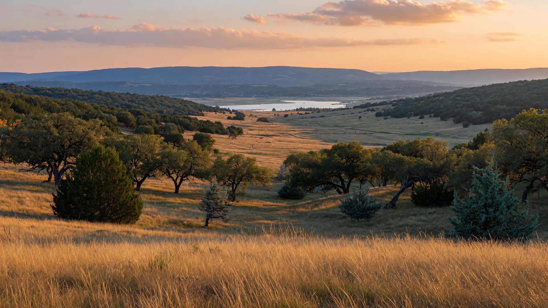 Rolling Texas Hill Country at golden hour near Belton, with a distant glint of lake water