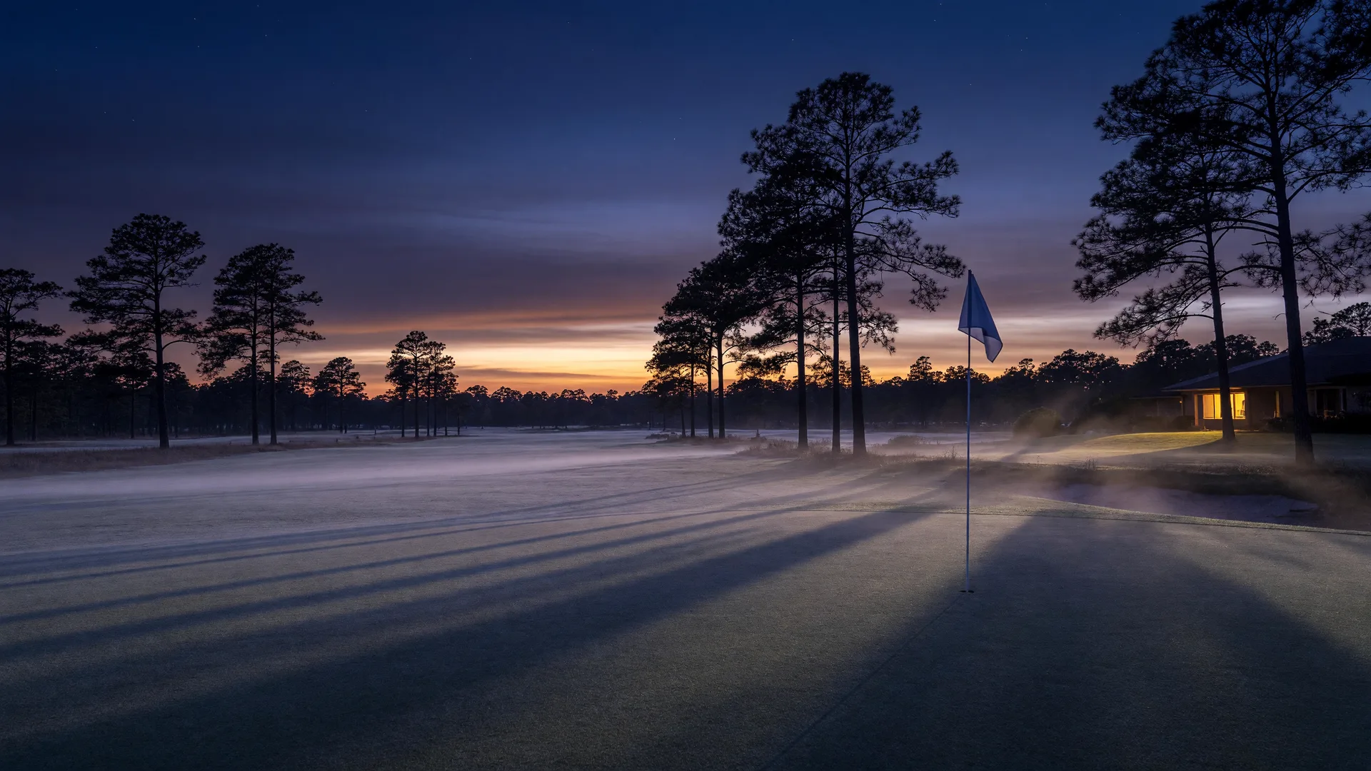 Twilight fairway in the North Carolina sandhills with a flag against the dusk sky
