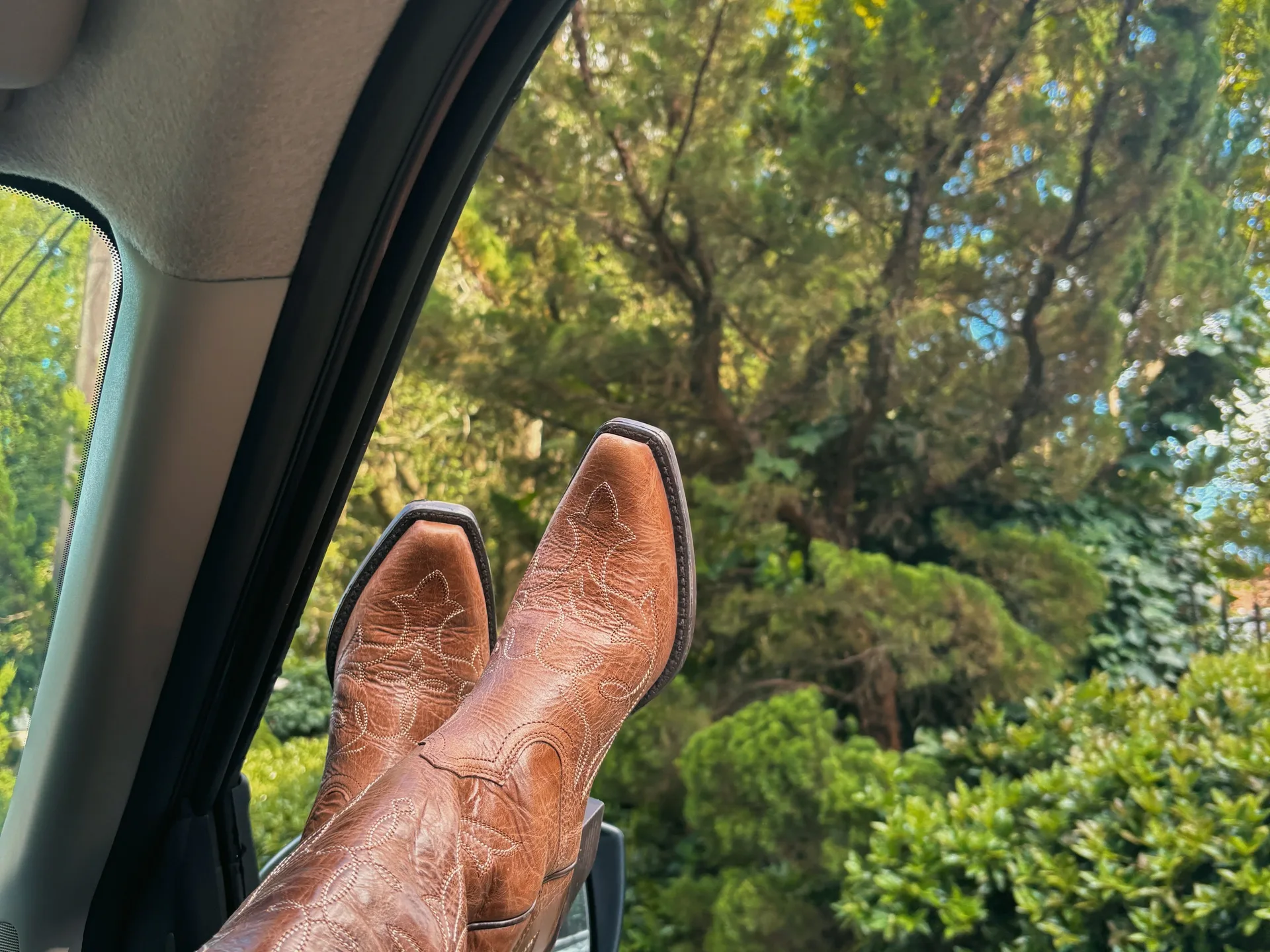 Cowboy boots resting on a wooden porch step, symbolizing the start of a new journey in Texas
