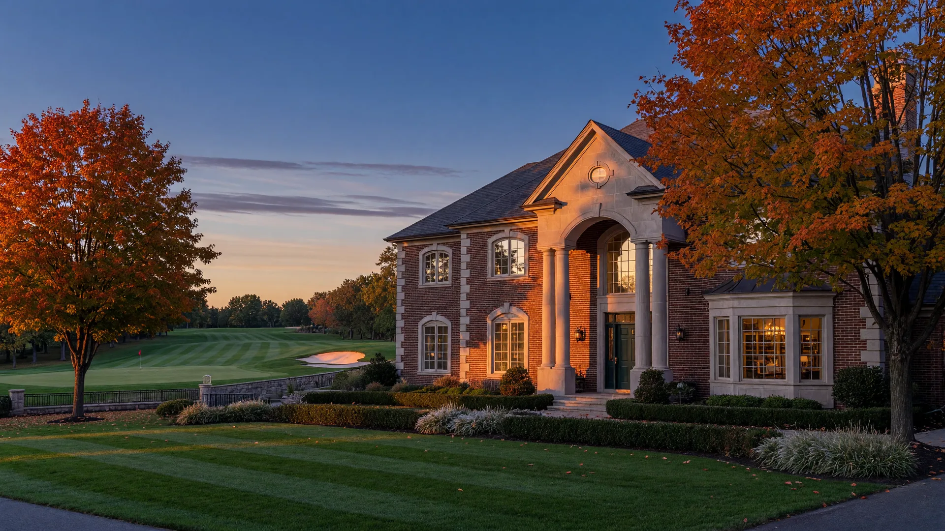 Elegant brick and stone luxury home in Apalachee Farms at October golden hour, autumn maples framing the facade and the golf course fairway behind, representing the 2026 housing market reset